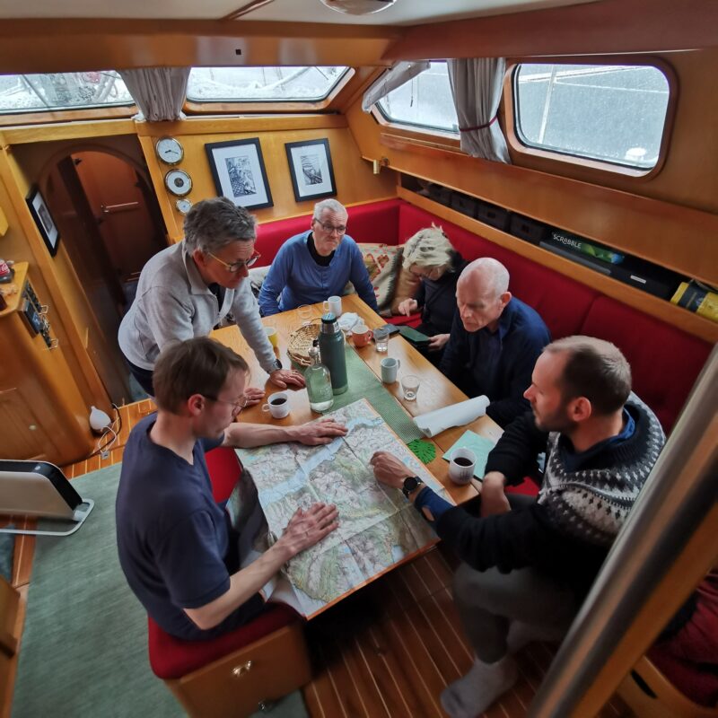 Tourers going over an itinerary in a sailboat in Norway