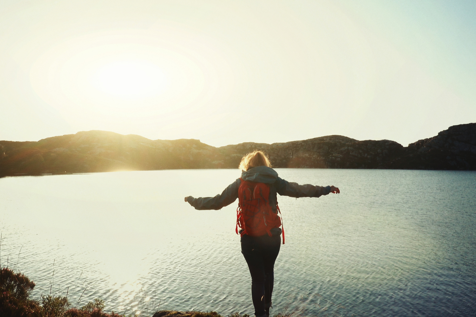 Hiker posing in front of a lake in Western Norway