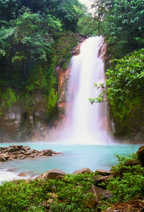 A secluded waterfall in a tropical rainforest. This is the Celeste Waterfalls in Costa Rica (Catarata Celeste).