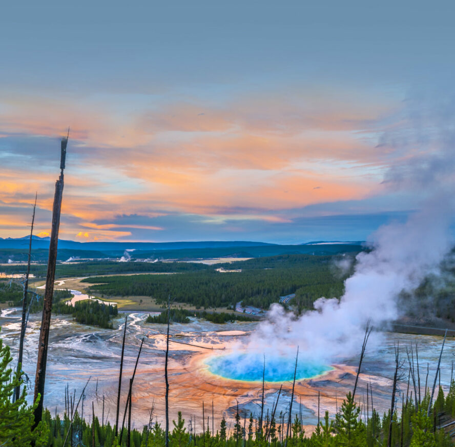 The Grand Prismatic Springs, a massive geothermal pit bubbling with microbial life and vibrant colors.