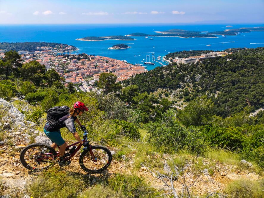 Mountain biker riding the flowy trails above the port town of Hvar in Croatia.