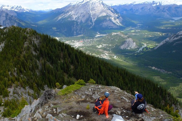 Hikers overlook the valley and town of Banff while making their way along the Sulphur Mountain hiking trail. 