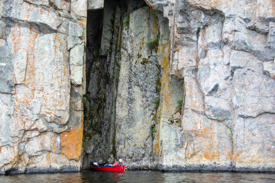 A canoer next to a cliff at the Porcupine River