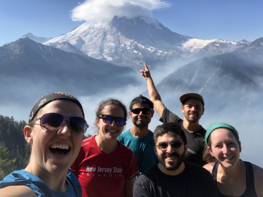 Group of hikers enjoying the view of Mount Rainier under a lenticular cloud.