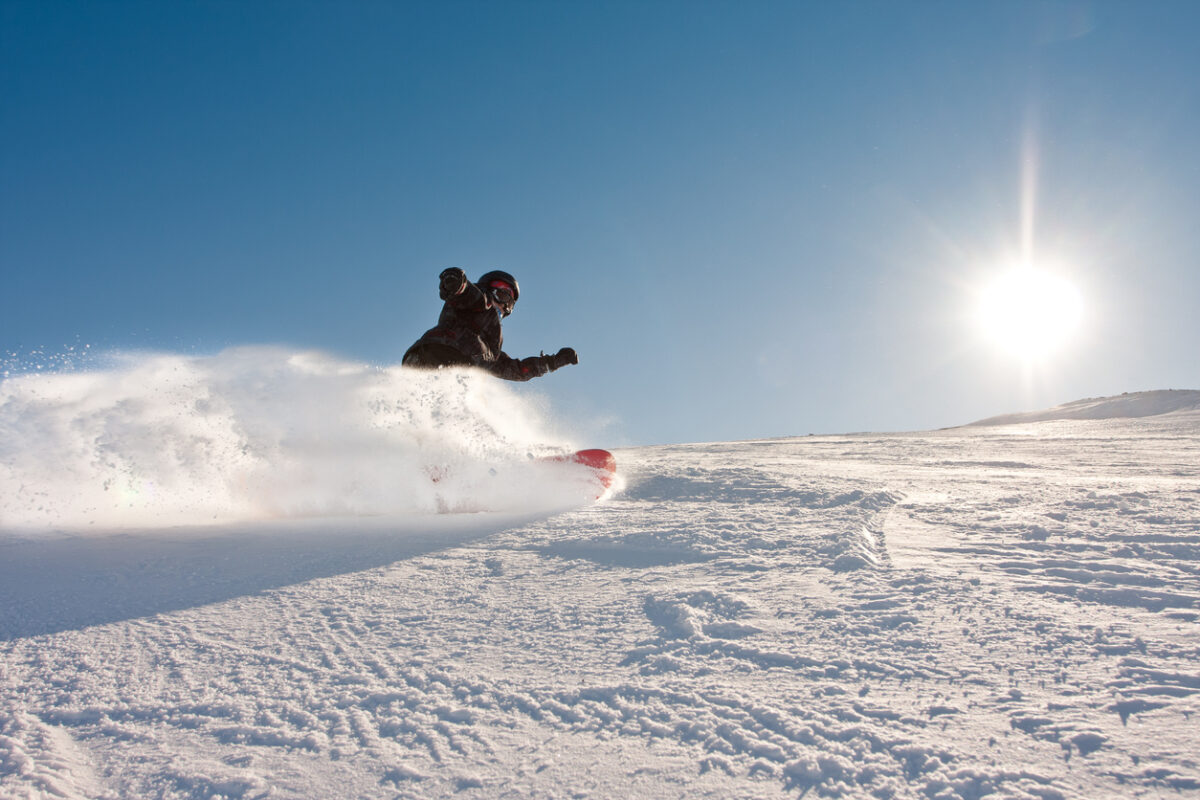 A man skiing and the sun.