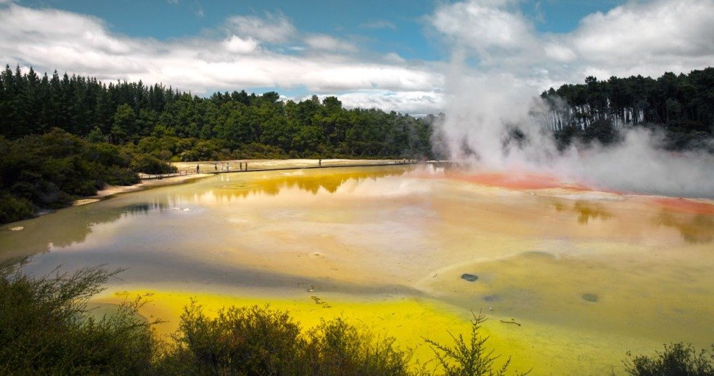 View of a lake south in the Rotorua area with recognizable geothermal features such as steam plumes and unusual color.