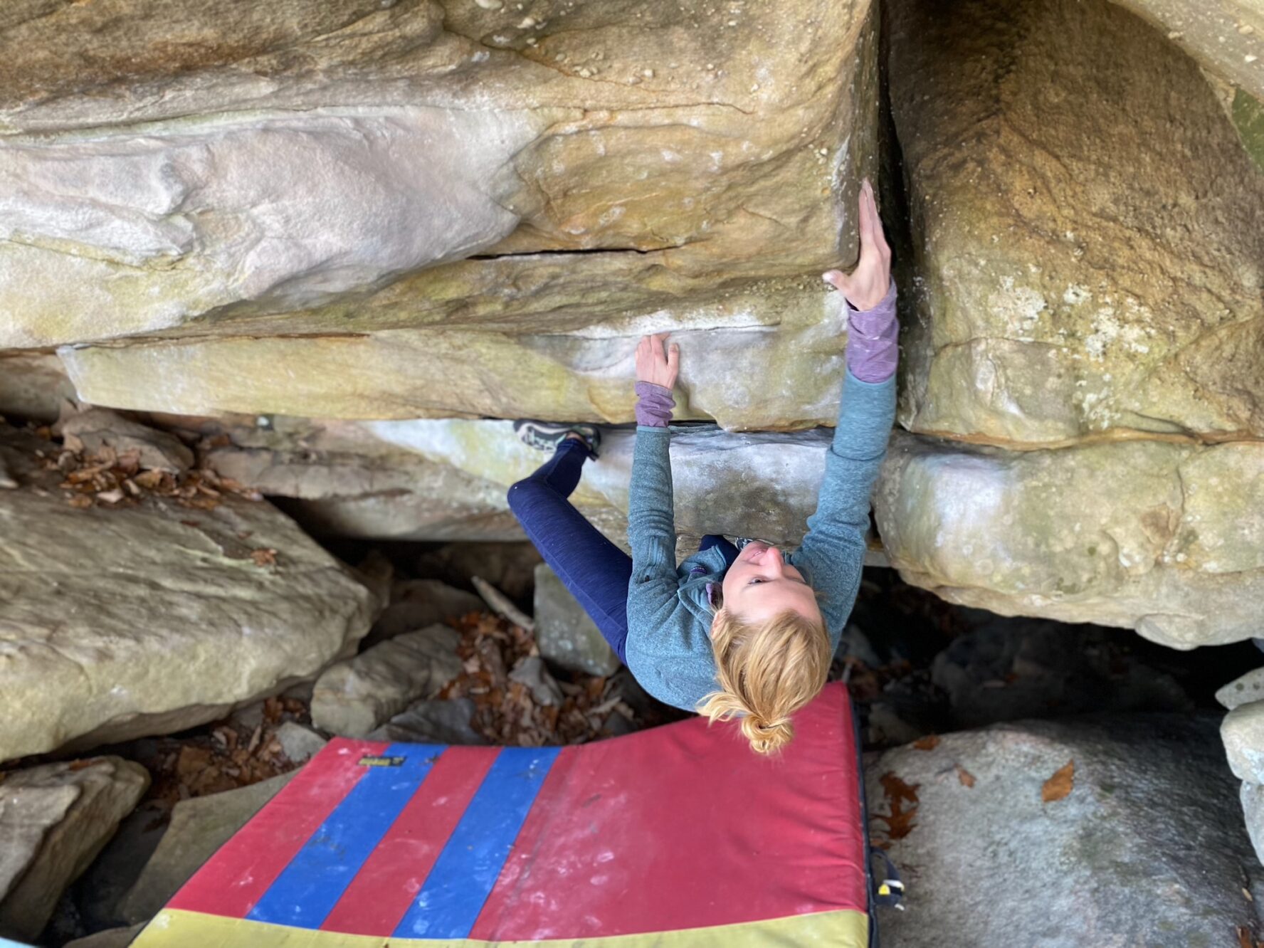 A climber slaps her way up the problem Diesel Power (V5) at Stone Fort.
