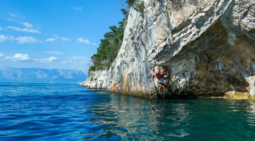 A climber deep water soloing in Croatia. 