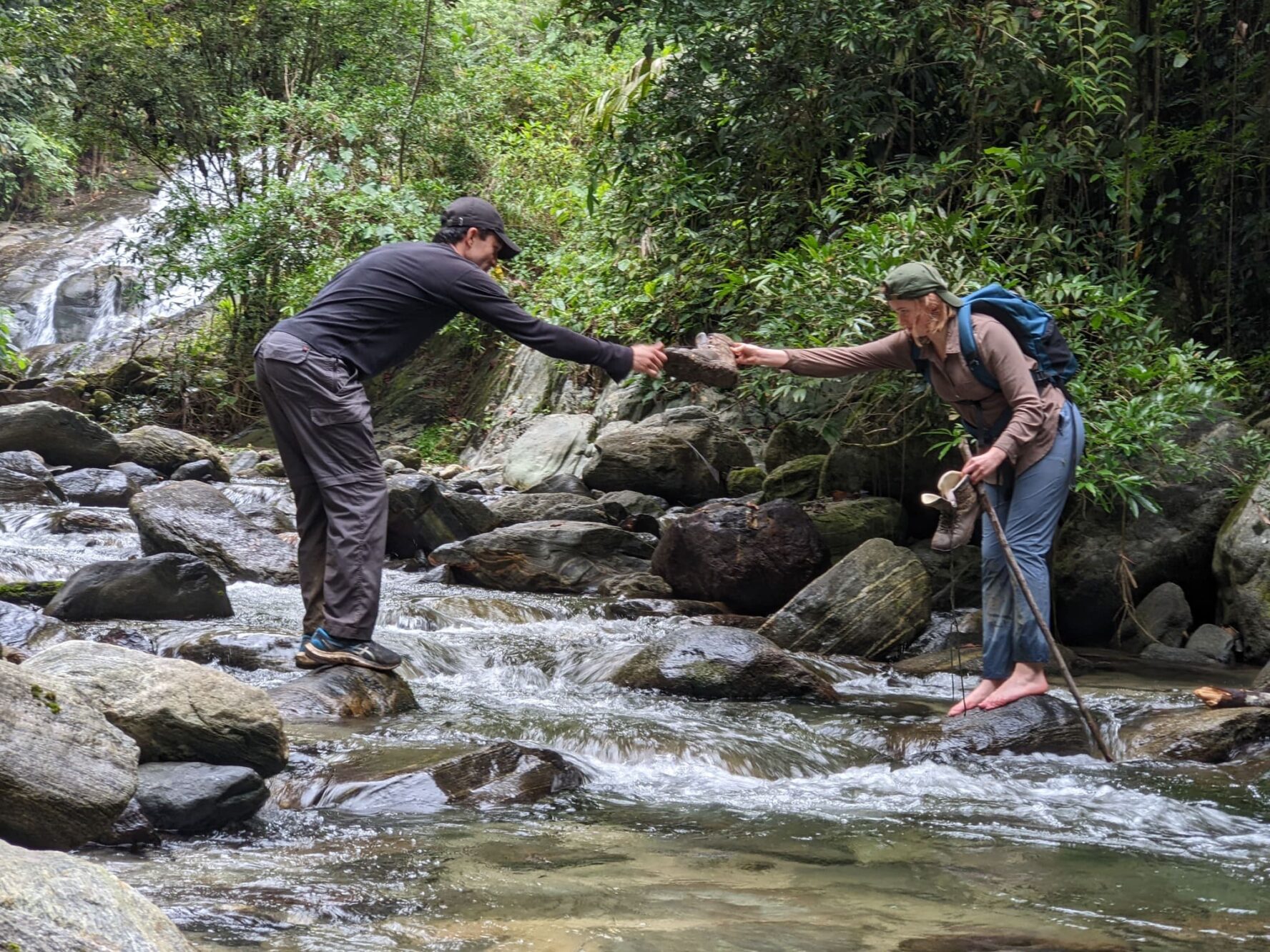 Hikers crossing a river.