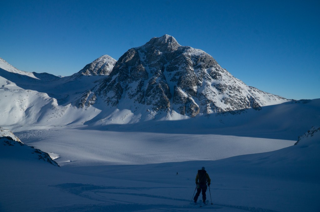 One skier below a mountain