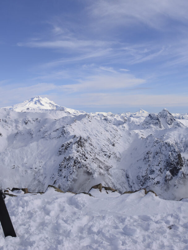View of a frozen lake encircled by golden granite peaks close to refugio Frey.