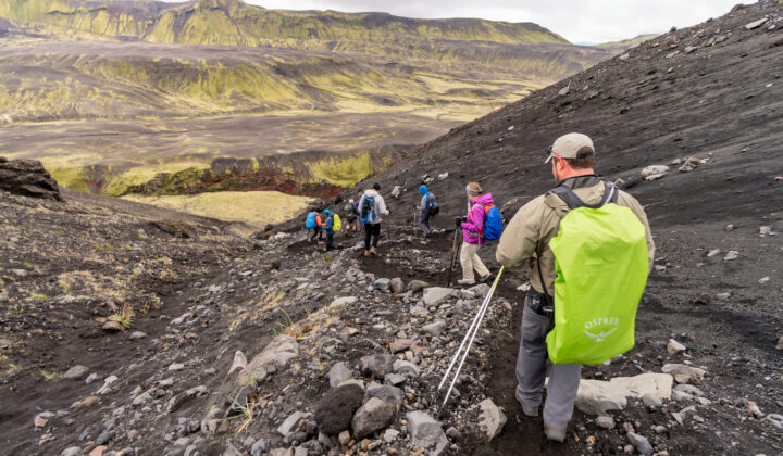 Hikers traversing the volcanic landscape in Iceland.