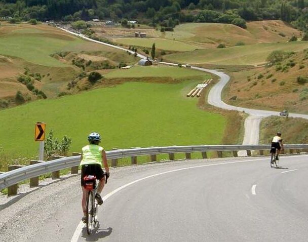 Three cyclists on a street of Italian town
