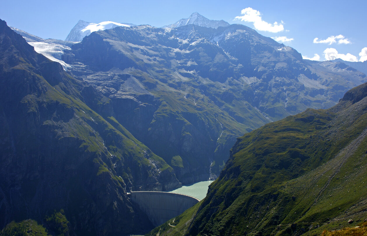 Mauvoisin reservoir surrounded by a dam and Swiss mountains.