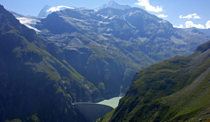 Mauvoisin reservoir surrounded by a dam and Swiss mountains.