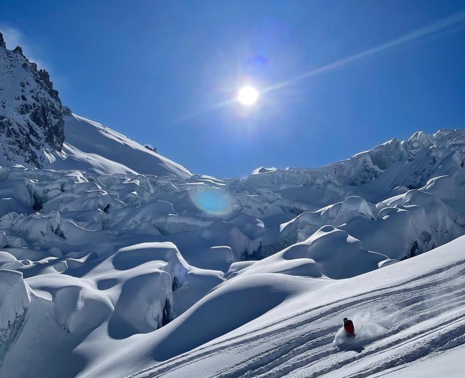 A backcountry skier shredding a powder-laden slope near Chamonix.