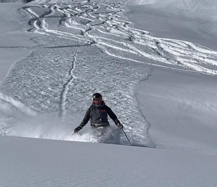 A backcountry skier shredding powder on an off-piste slope near Chamonix, France.