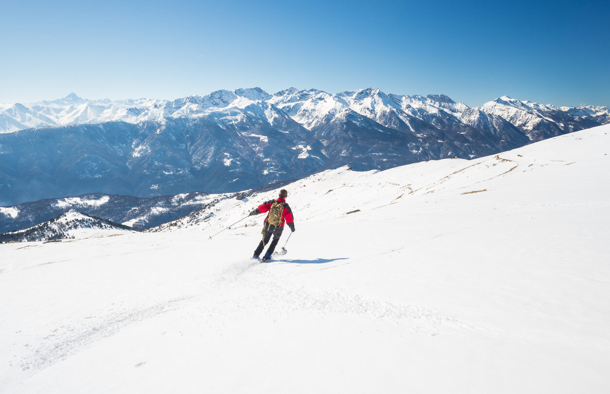 A skier on a slope near the mountain town of Courmayeur, Italian Alps.