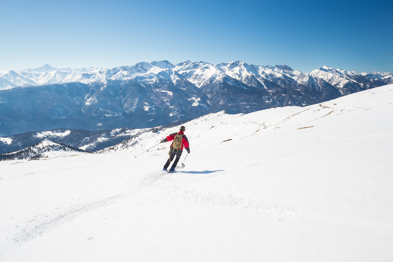 A skier on a slope near the mountain town of Courmayeur, Italian Alps.